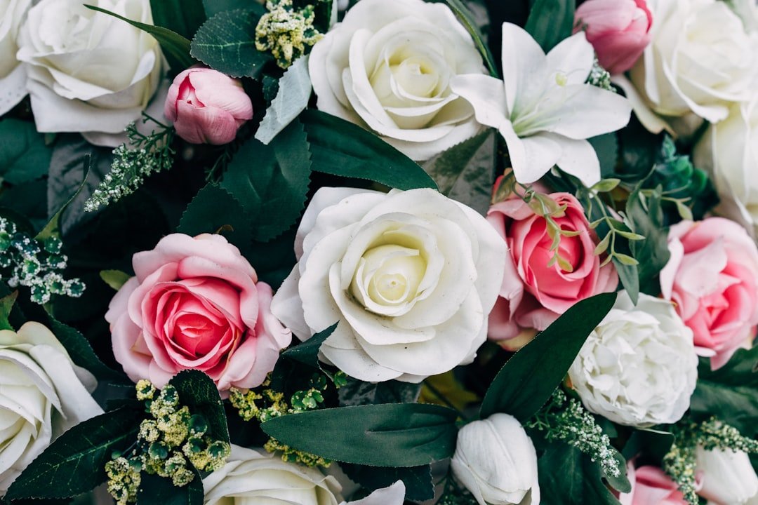 white and pink artificial funeral flower tribute