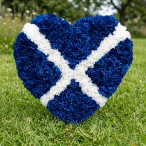Funeral flowers heart tribute blue cross