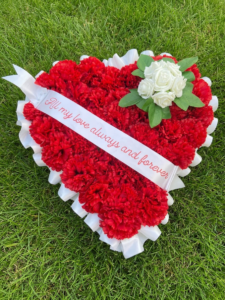 Funeral flowers heart tribute red