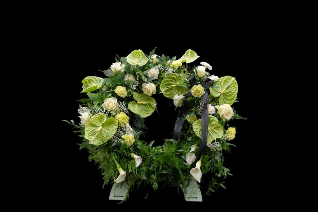 A circular floral arrangement with white and green flowers